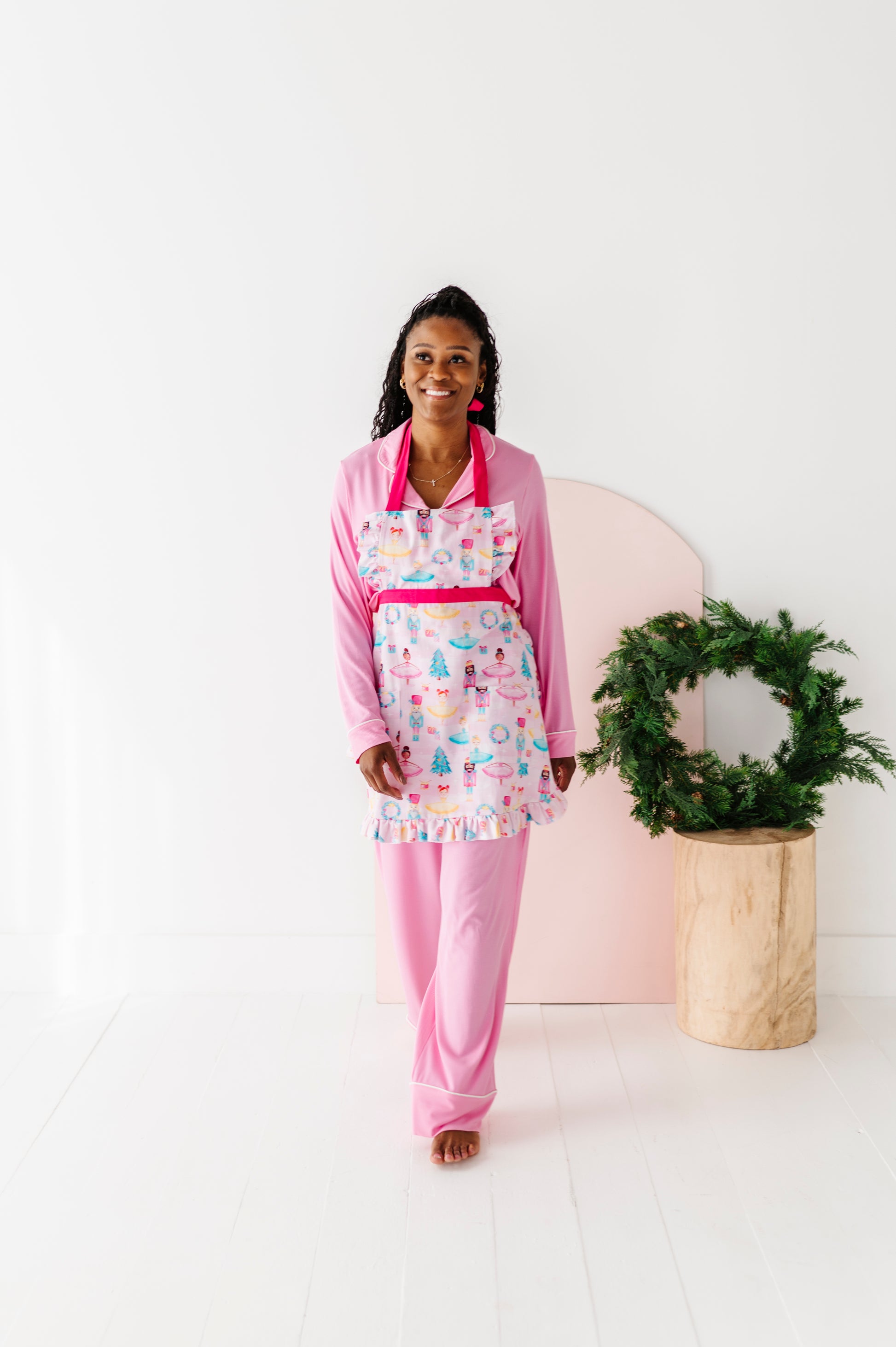 Sugarplum baking apron featuring ballerinas and nutcrackers on pink background