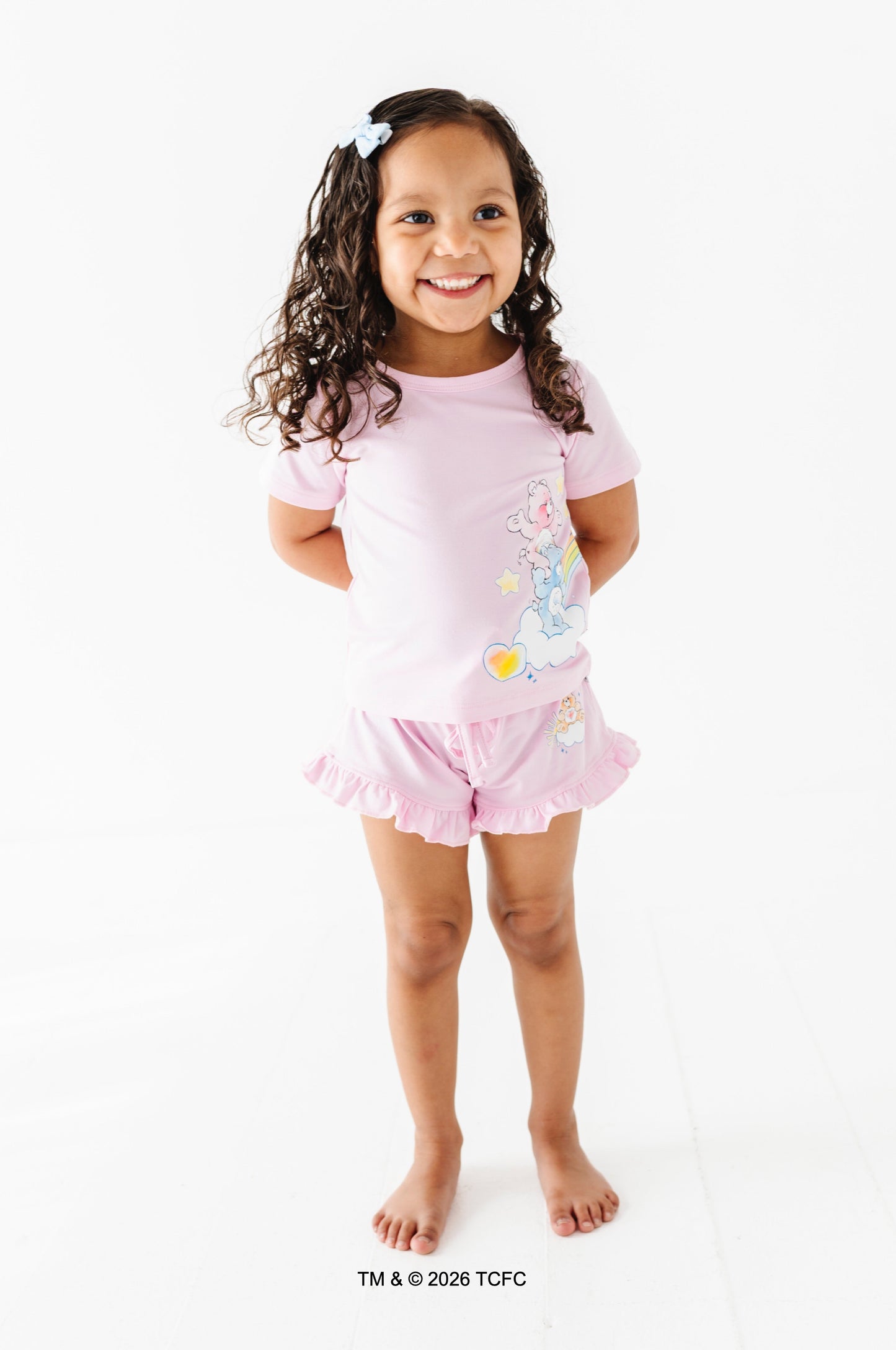 Young girl wearing a lilac bamboo outfit with Care Bears™ on a white background