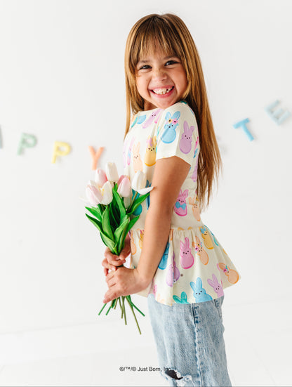 Young girl holding a bouquet of flowers, wearing a colorful PEEPS® shirt 