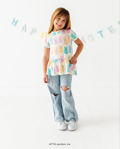 Child wearing a colorful PEEPS®  shirt on a white background