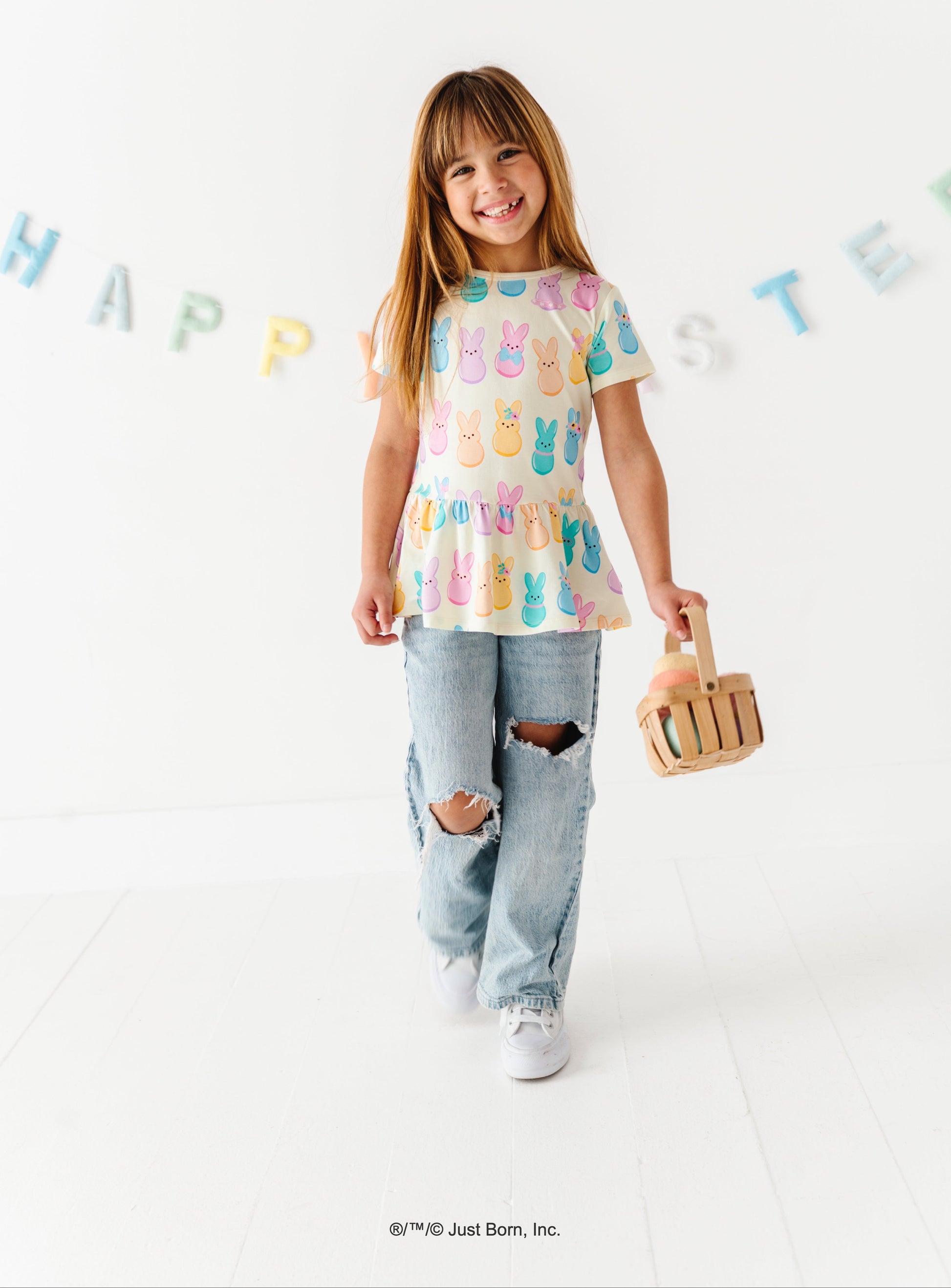 Child wearing a PEEPS®  shirt with bunny designs on a white background