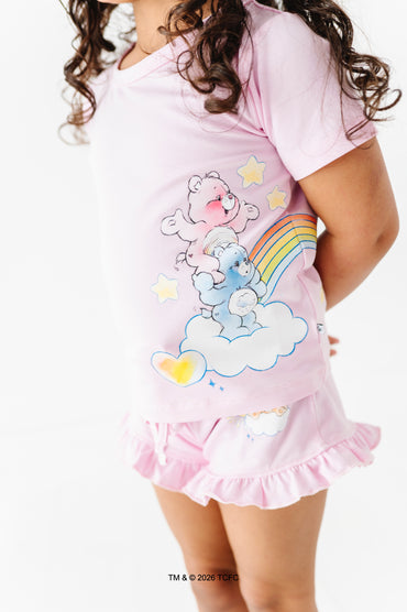Pink pajama set with cartoon bear design on a white background