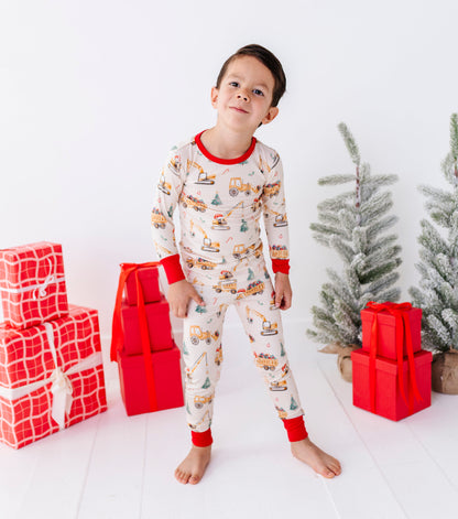 A little boy wearing construction-themed bamboo pajamas 