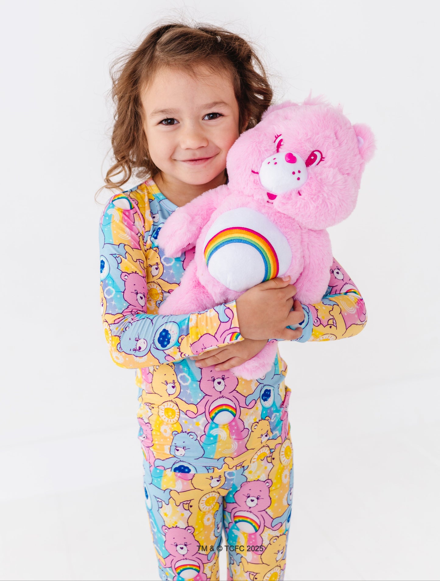 Toddler wearing Care Bears™ Stare bamboo pajamas featuring Cheer Bear, Funshine Bear, and Grumpy Bear print