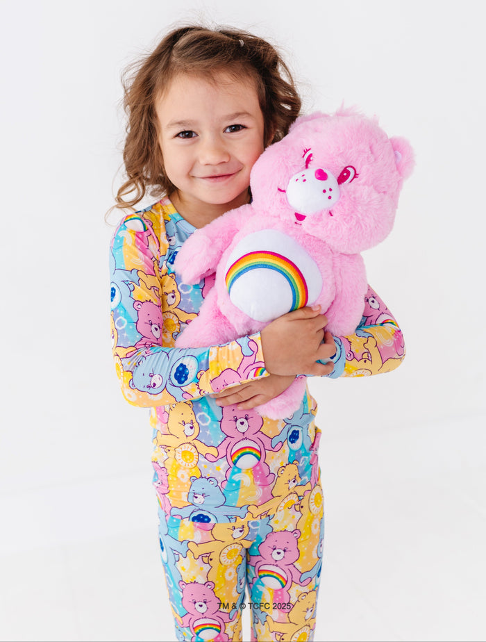 Toddler wearing Care Bears™ Stare bamboo pajamas featuring Cheer Bear, Funshine Bear, and Grumpy Bear print