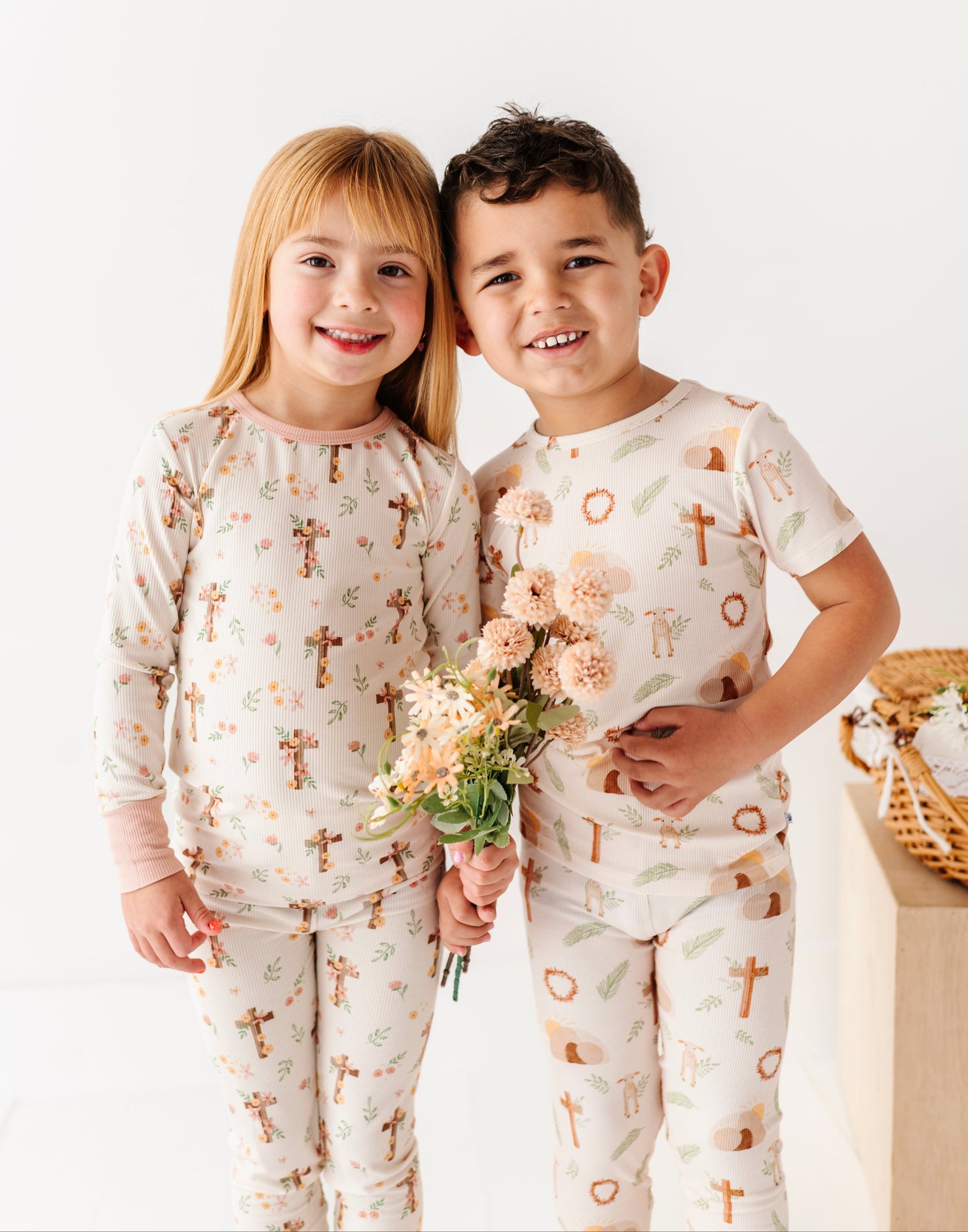 Two children wearing bamboo pajamas with a floral pattern on a white background