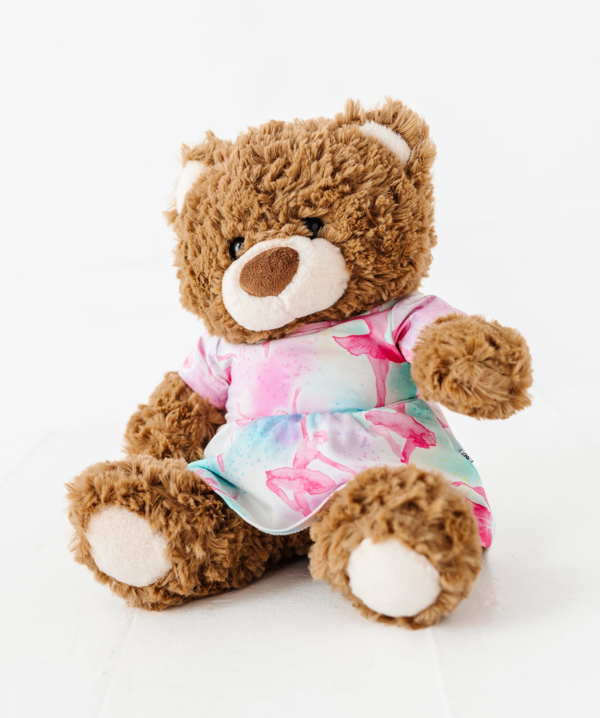 Plush teddy bear wearing a watercolor bamboo outfit on a white background