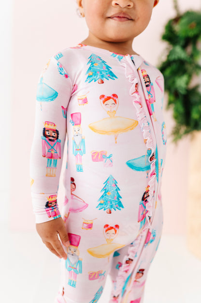 Child wearing a light pink bamboo pajama with Nutcracker design 