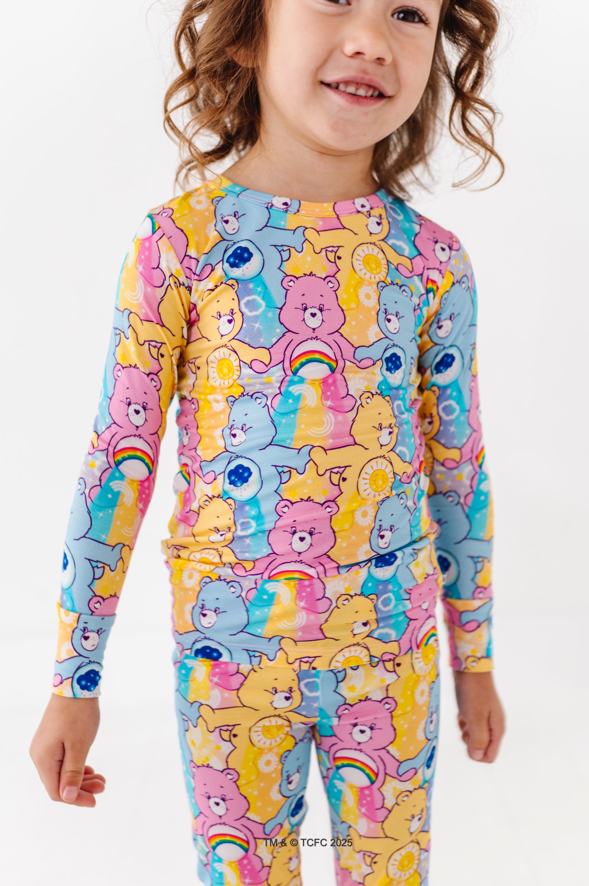 Close-up of Care Bears™ Stare pajama set showing vibrant bear characters and belly badge details