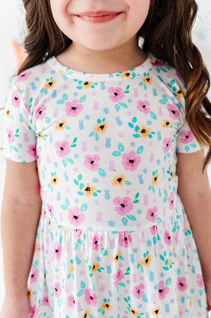 Little girl wearing a PEEPS® floral dress with a white background