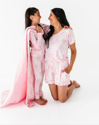 Mom and daughter in pink bamboo two-piece pajama sets on a white background