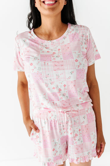 Woman wearing a pink floral pajama set on a white background