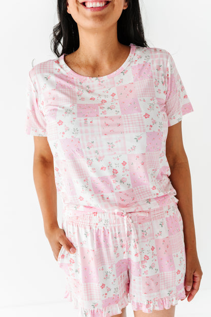 Woman wearing a pink floral pajama set on a white background