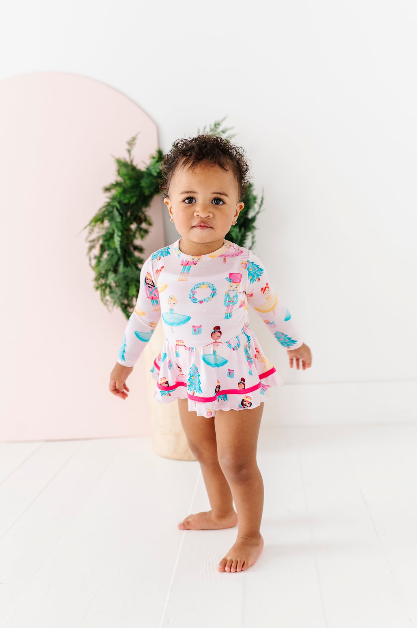Baby girl in pink Nutcracker bamboo twirl dress with ballerinas and toy soldiers