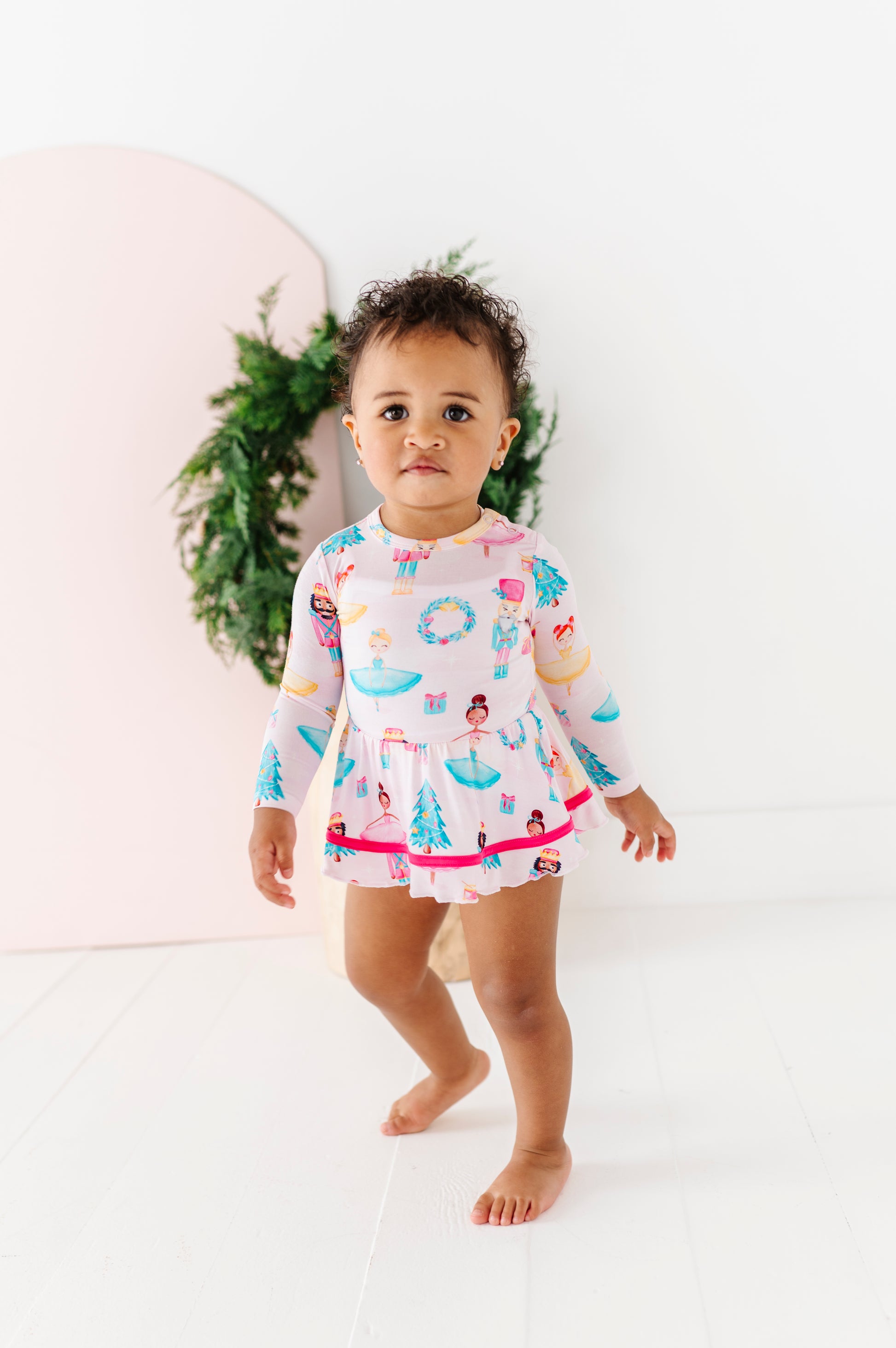 Baby girl in pink Nutcracker bamboo twirl dress with ballerinas and Christmas designs