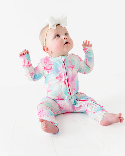 Baby wearing a colorful bamboo onesie with watercolor ballerina design on a white background