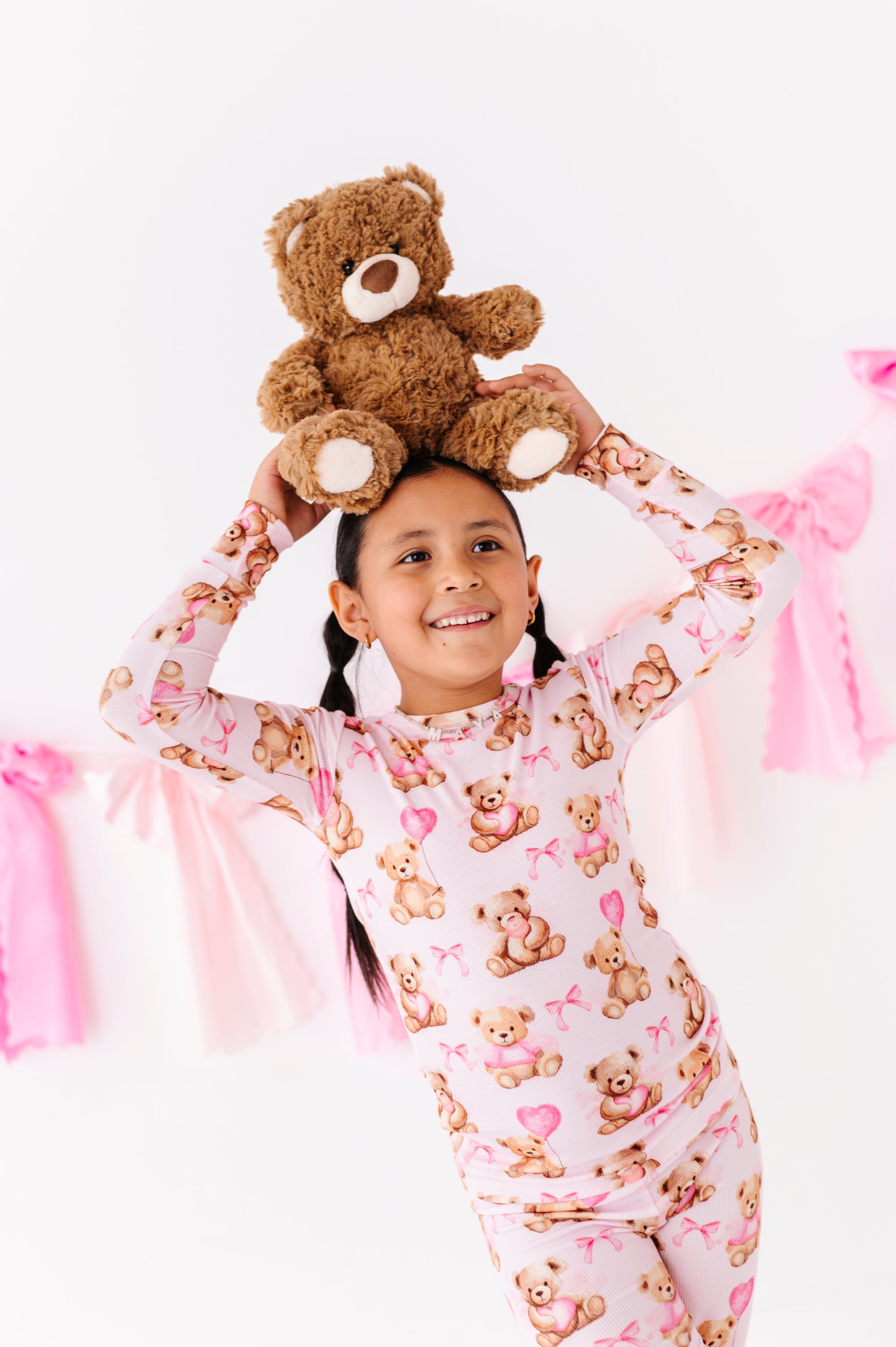 Child wearing Pink Beary Sweet ribbed bamboo pajamas with teddy bear and heart print