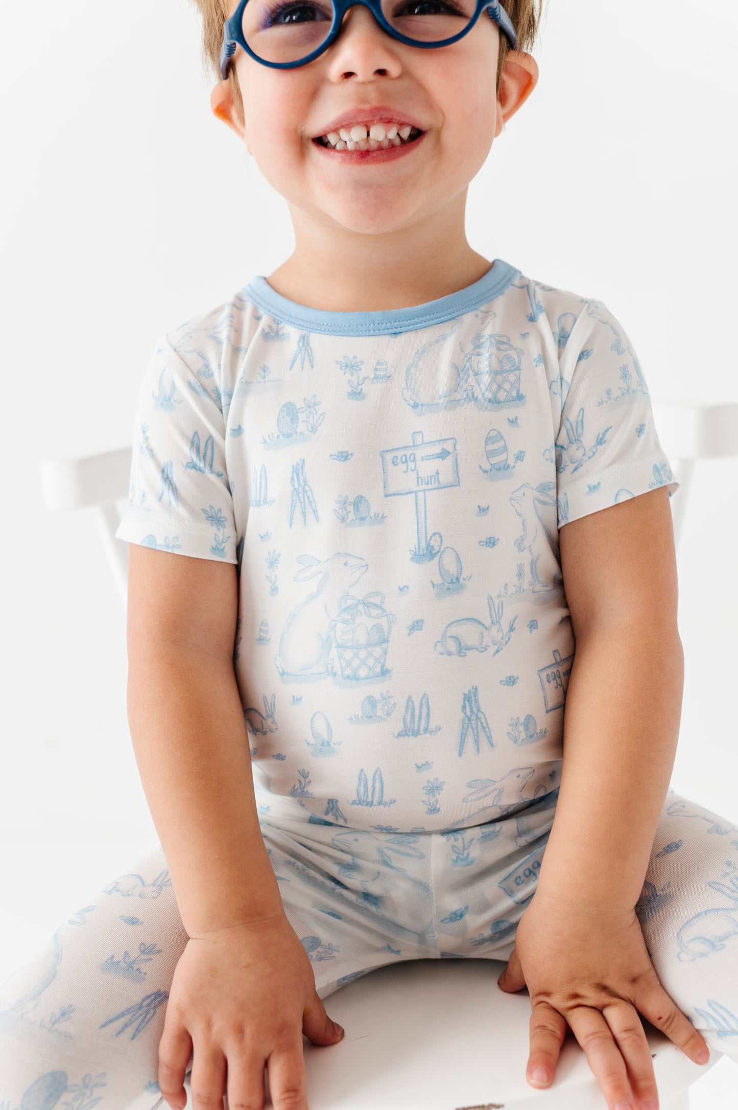 Child wearing a bamboo pajama set with blue patterns on a white background