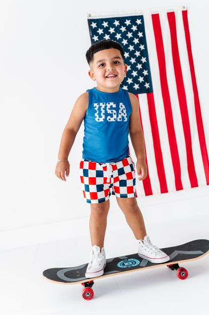 Child on a skateboard with an American flag in the background