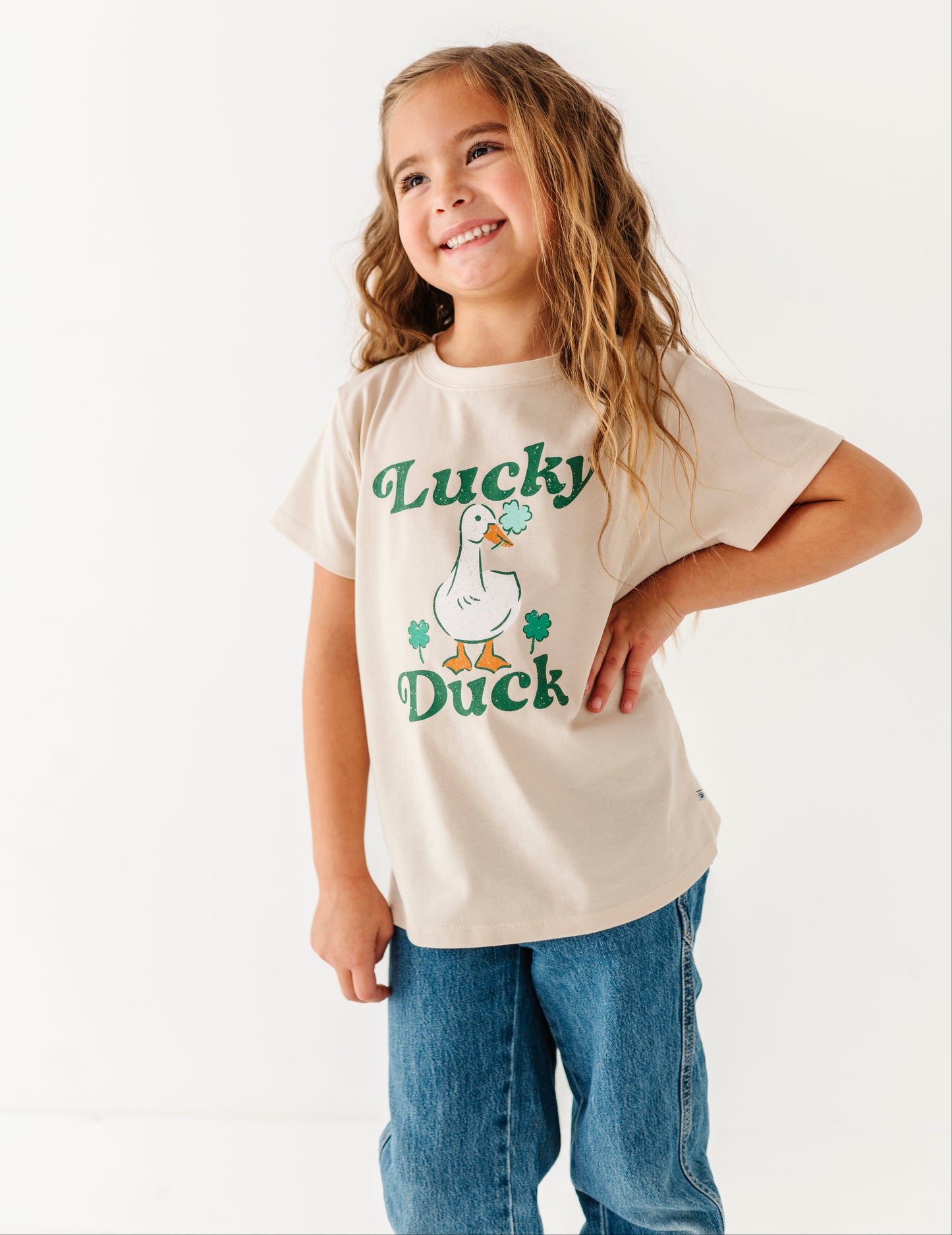 Child wearing a 'Lucky Duck' t-shirt on a white background
