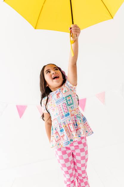 Child holding a yellow umbrella against a white background