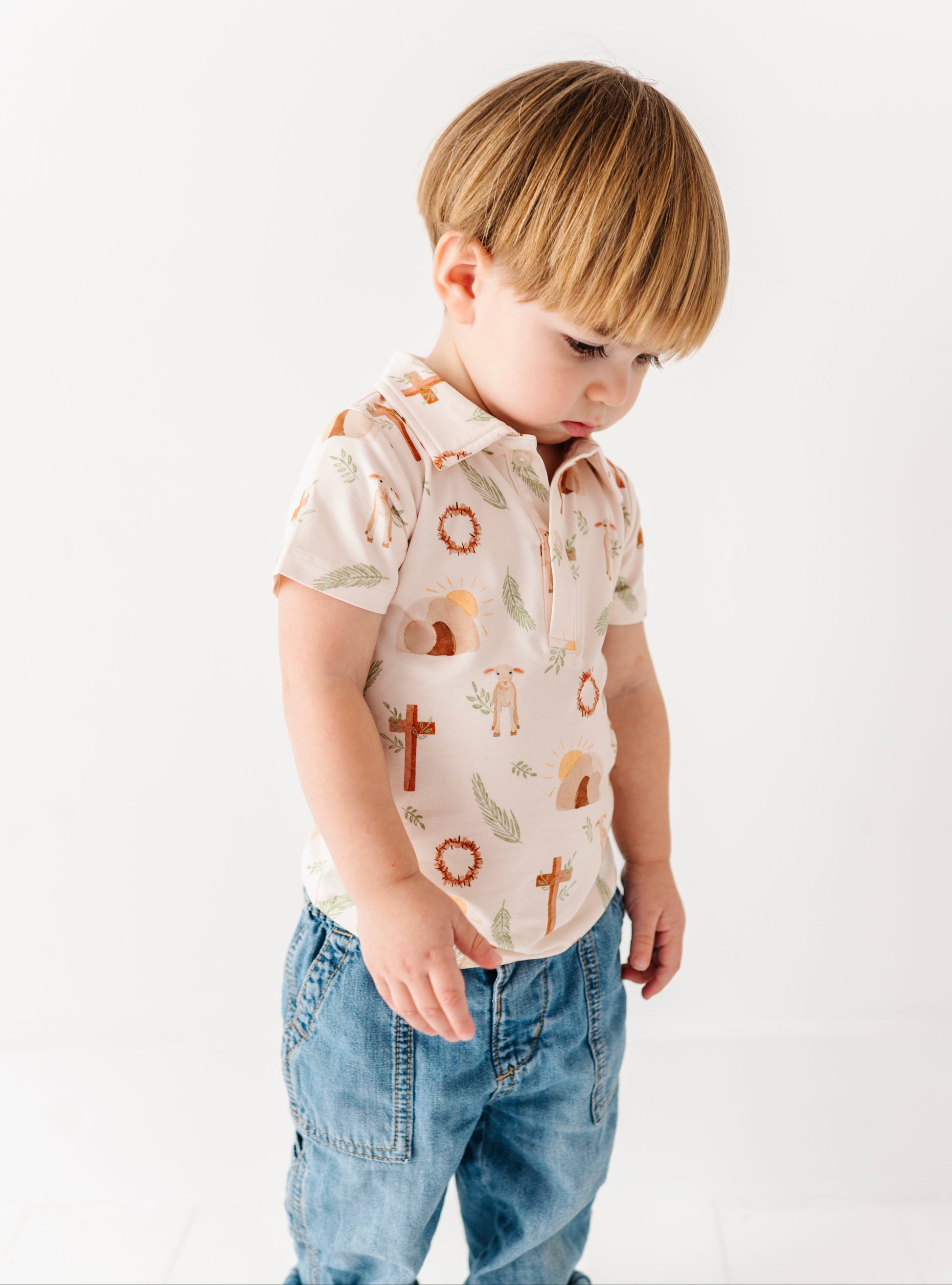 Child wearing a Easter themed  shirt and jeans on a white background
