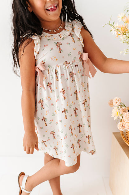 Child wearing a floral bamboo dress with a white background