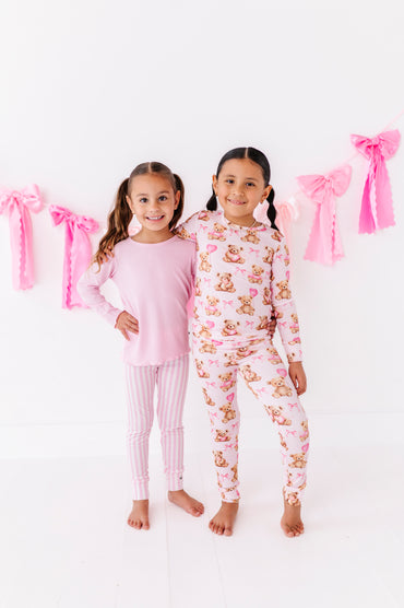 Pink ribbed lettuce hem top styled with striped leggings for girls