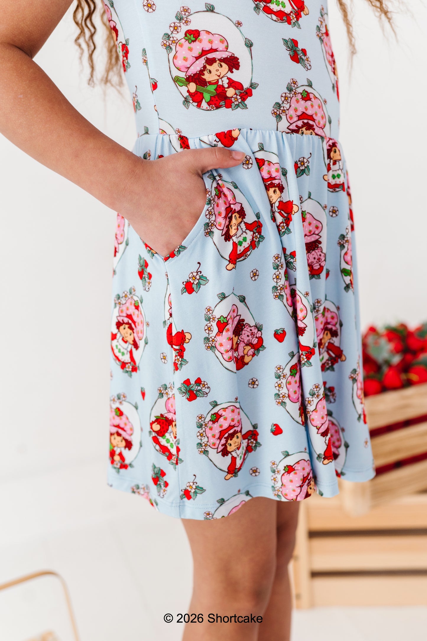Little girl wearing a Strawberry Shortcake™ dress with pockets 