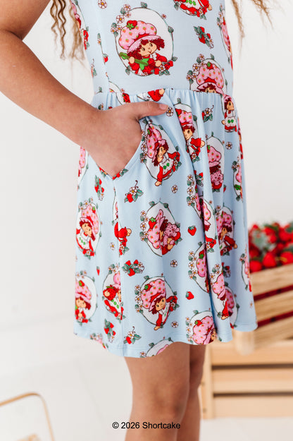 Little girl wearing a Strawberry Shortcake™ dress with pockets 