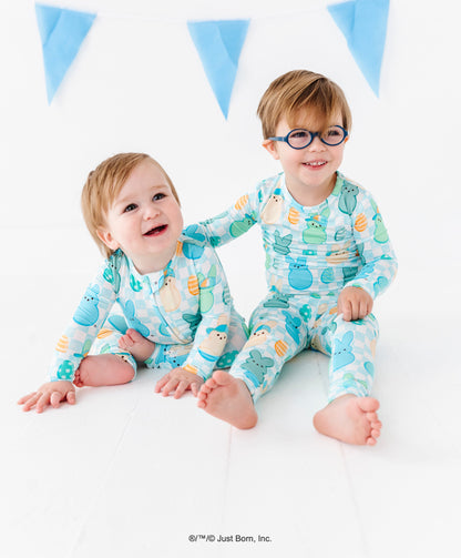 Two children wearing matching pajamas with a blue and white background