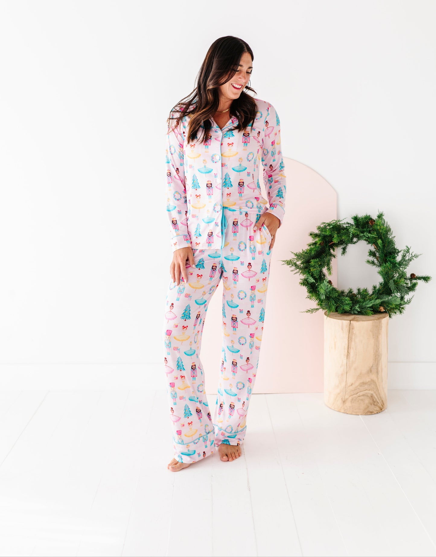 Woman wearing Christmas bamboo pajamas with a wreath on a white background