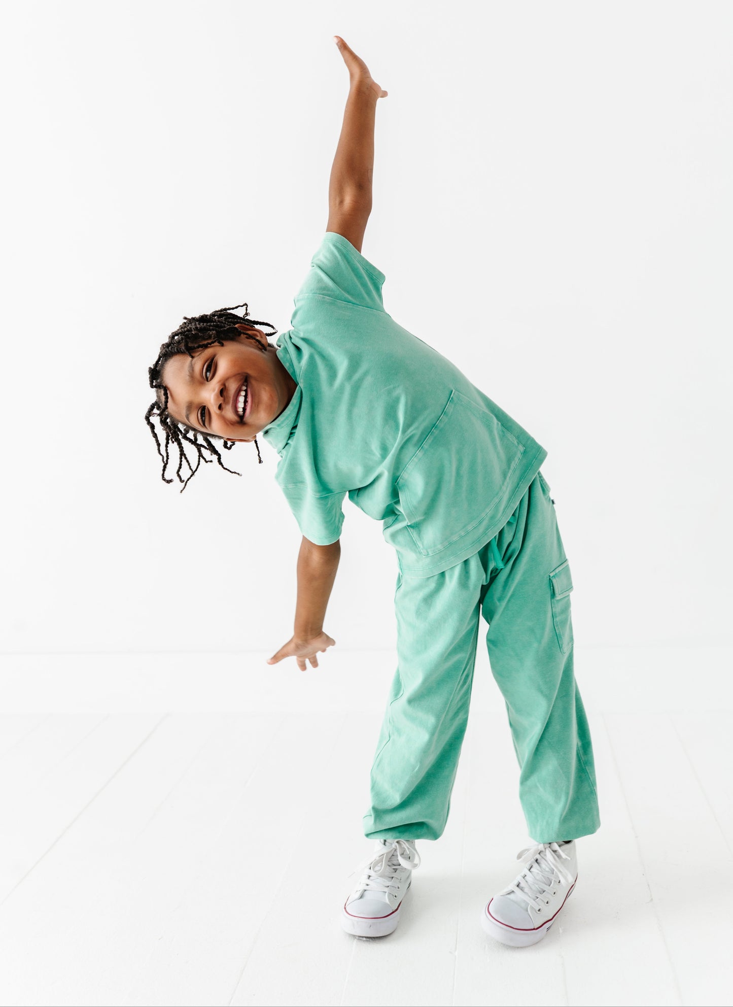 Person wearing a light green outfit on a white background