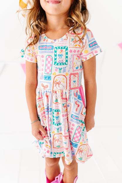 Child wearing a colorful patterned bamboo dress on a white background
