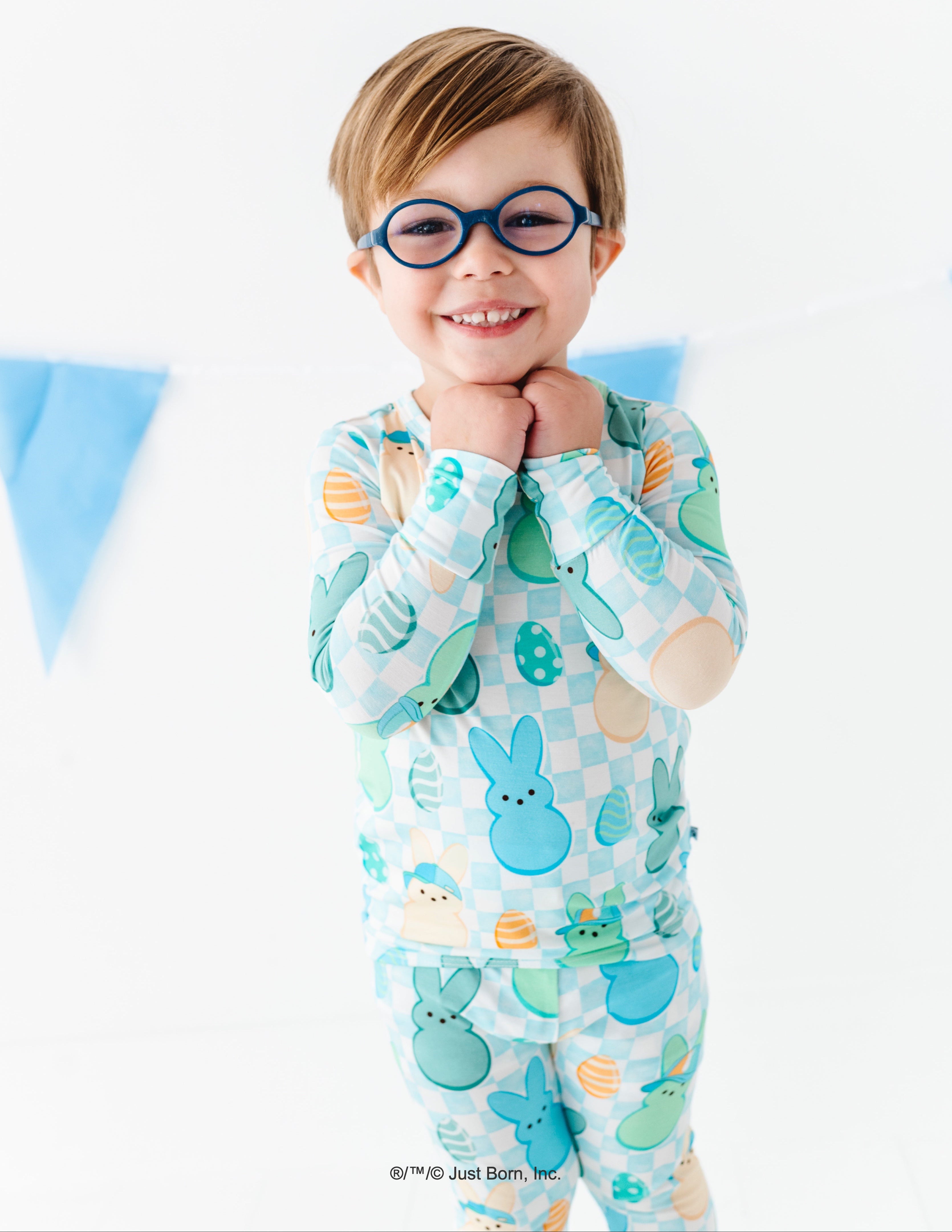 Child wearing a colorful pajama set with PEEPS® pattern on a white background