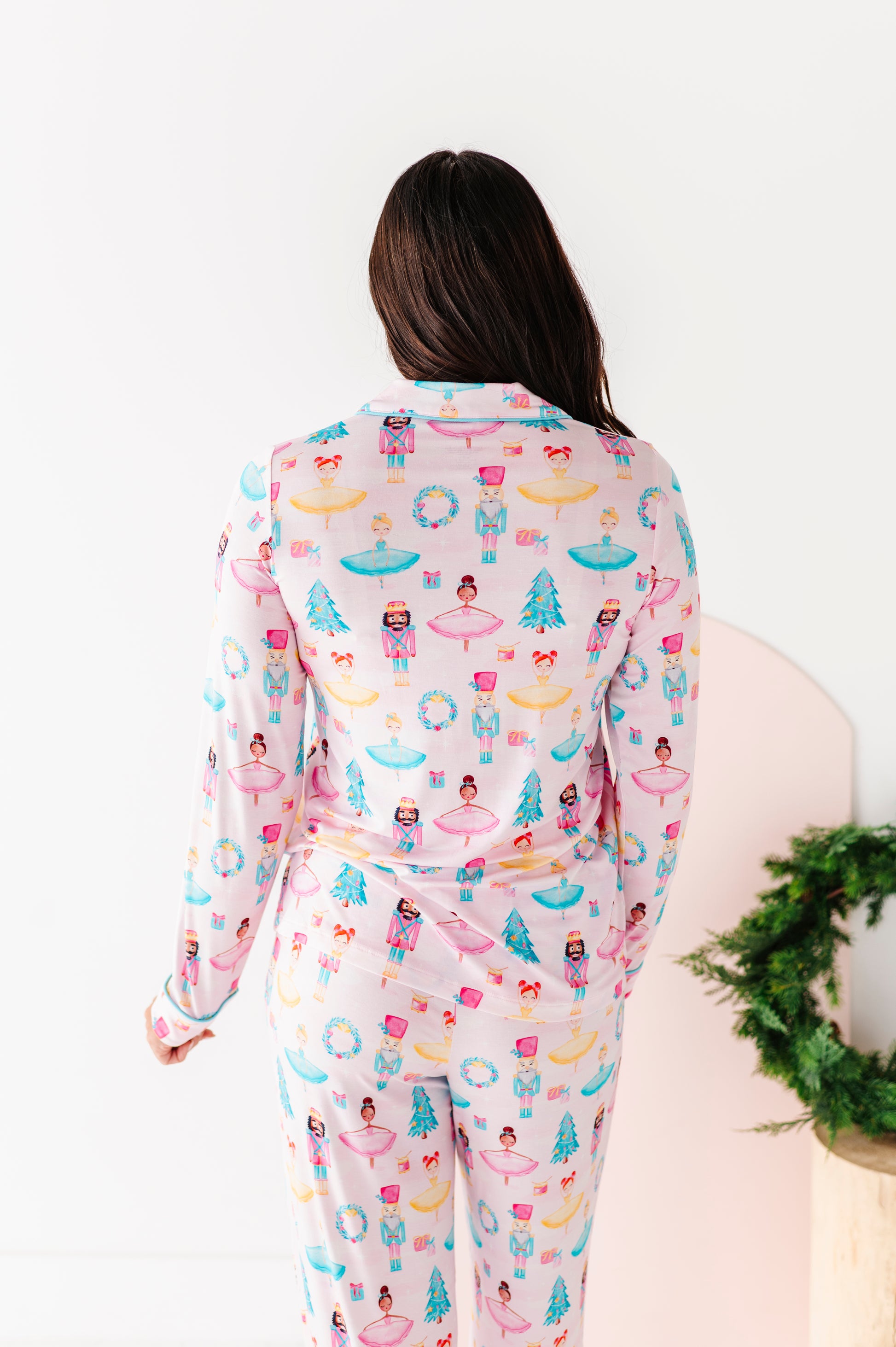 Mom wearing a light pink Christmas pajama set with ballerinas, trees, and nutcrackers 
