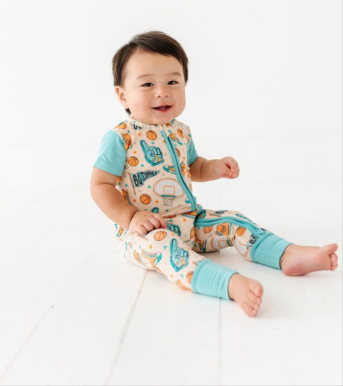 Baby wearing a basketball-themed bamboo outfit on a white background