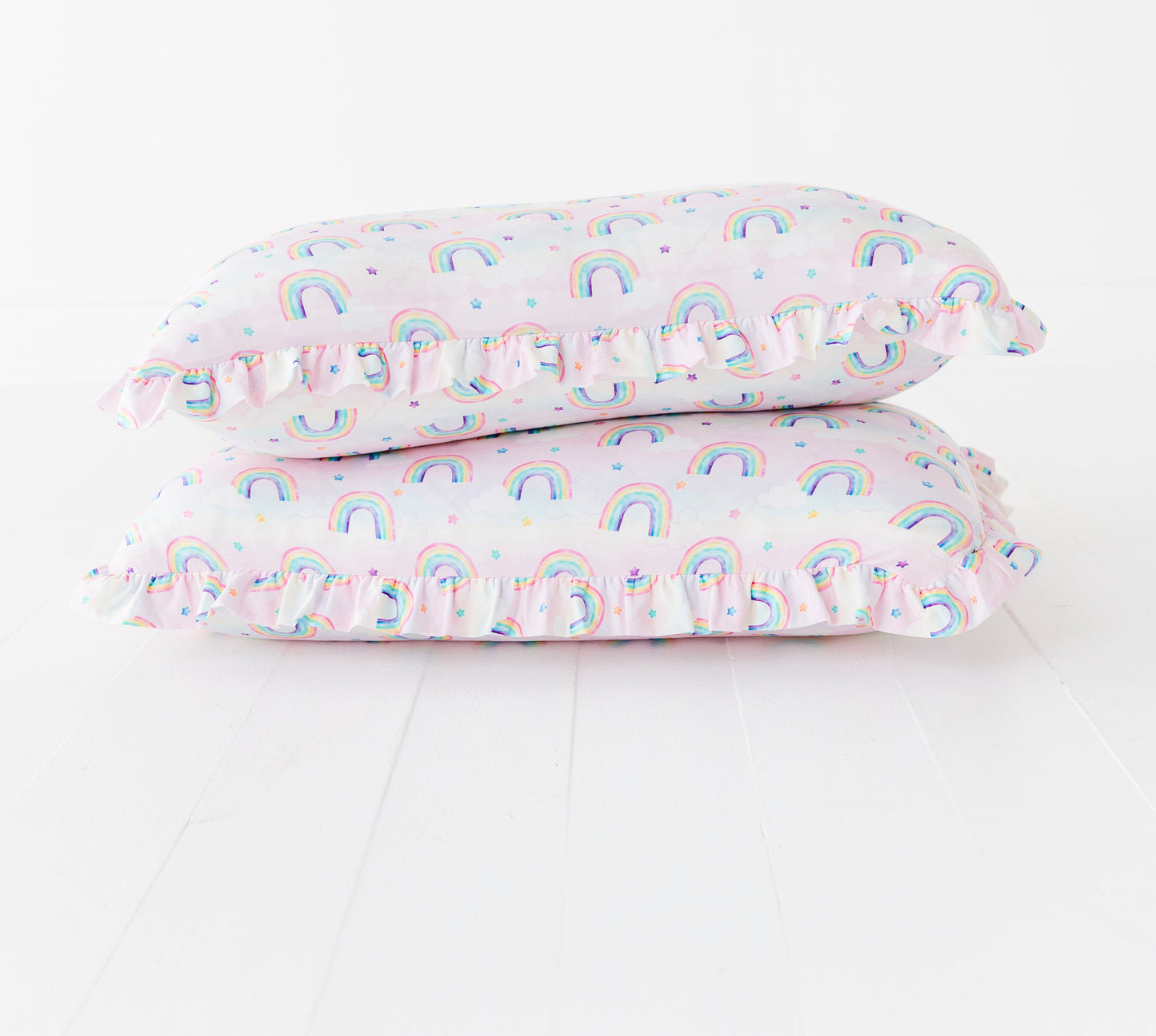 Two bamboo pillowcases with rainbow watercolor pattern on a white background