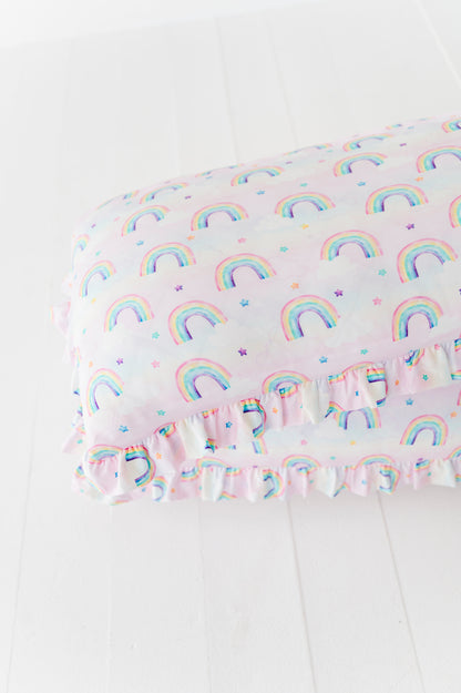 Two Rainbow Skies ruffle zipper pillowcases in a pastel rainbow and star print 