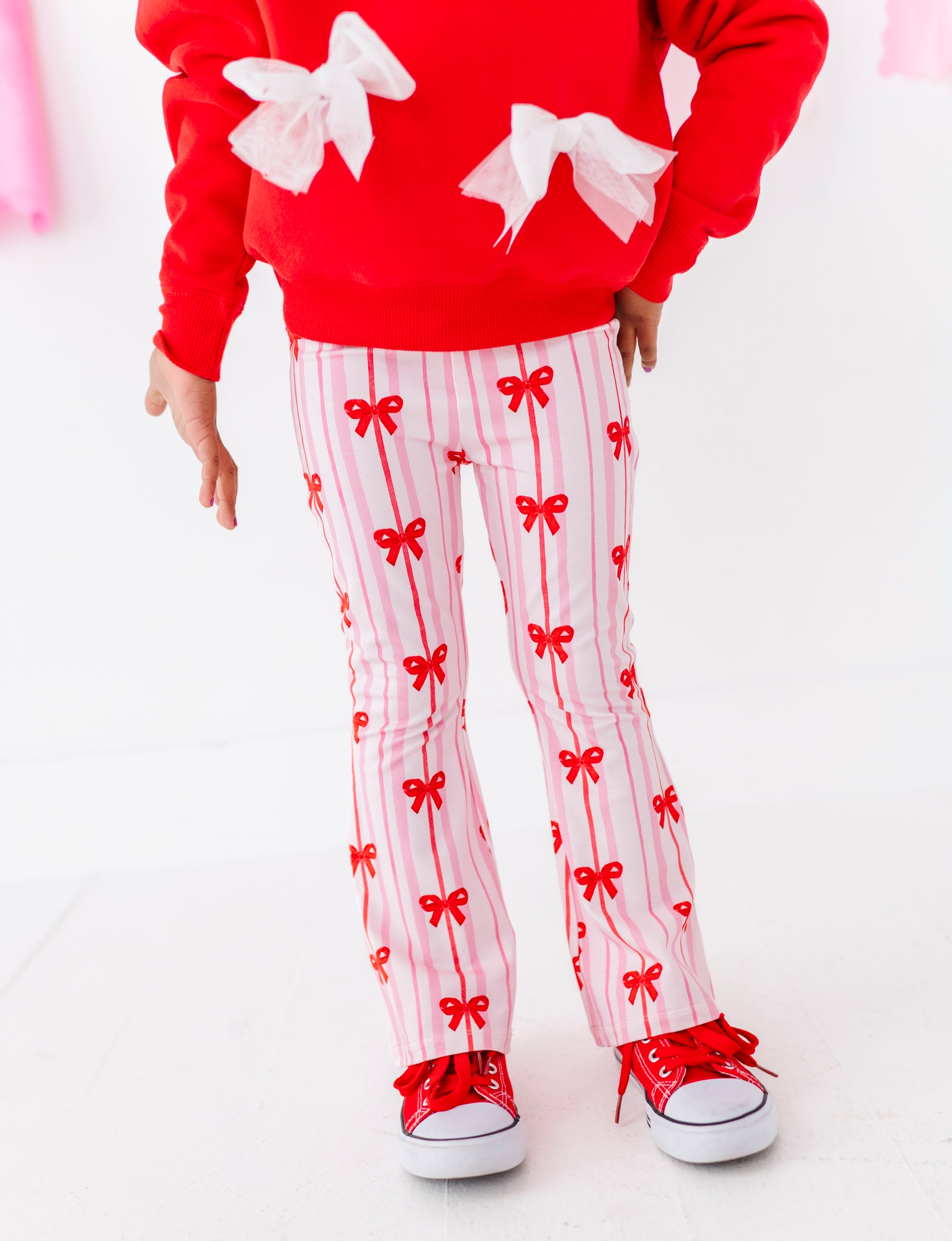 Detail view of red bow ribbon print on bamboo cotton children’s pants