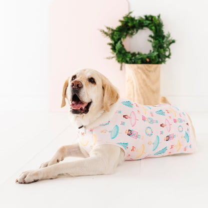 Dog wearing a bamboo pet sweatshirt featuring ballerinas, nutcrackers, presents, Christmas wreaths, and Christmas trees