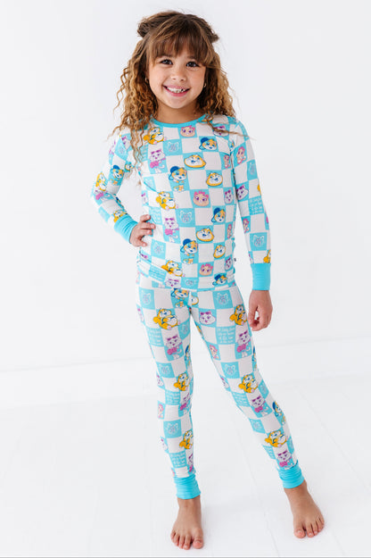 Child wearing a colorful bamboo pajamas set with cartoon 44 Cats characters on a white background