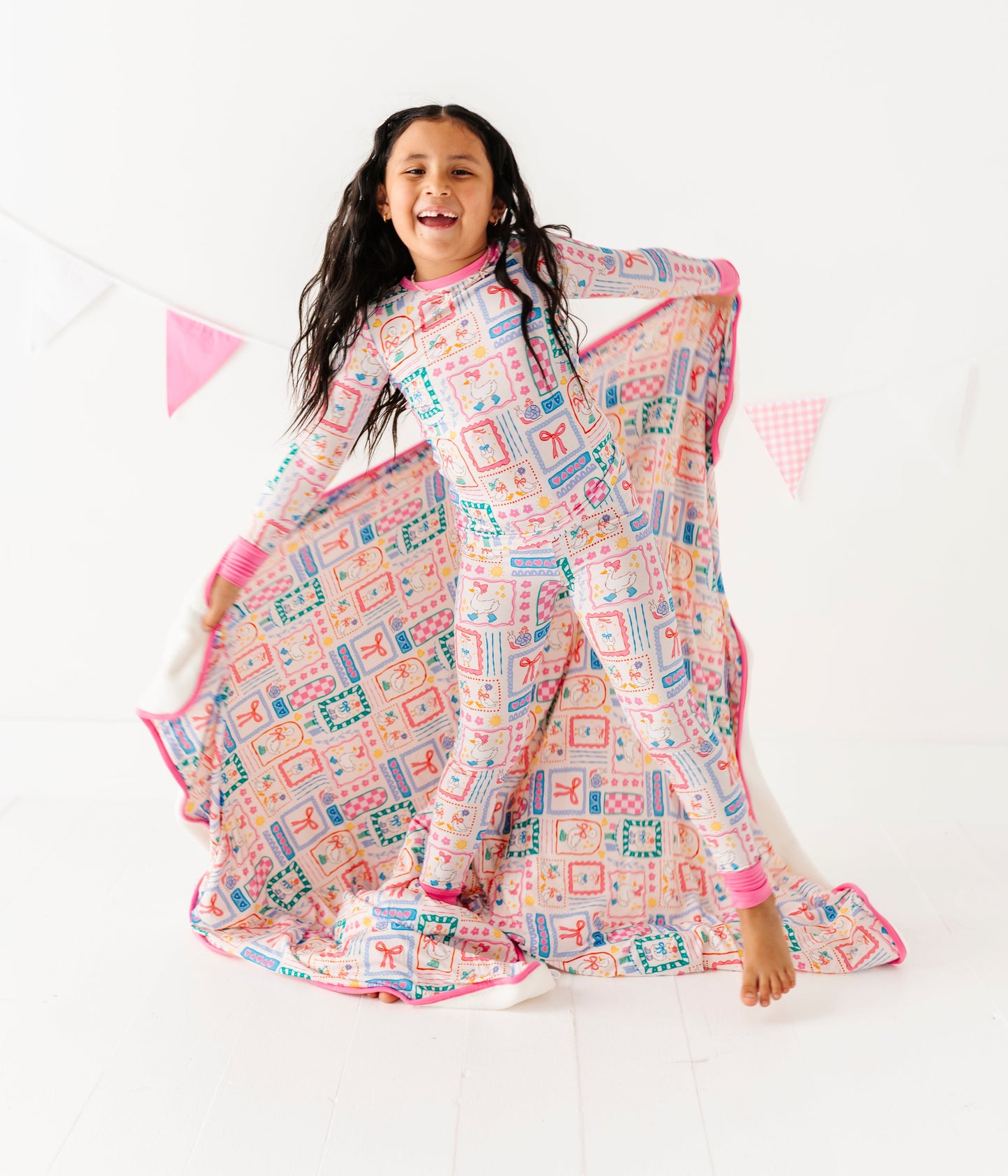 Girl wearing  colorful patterned pajamas on a white background