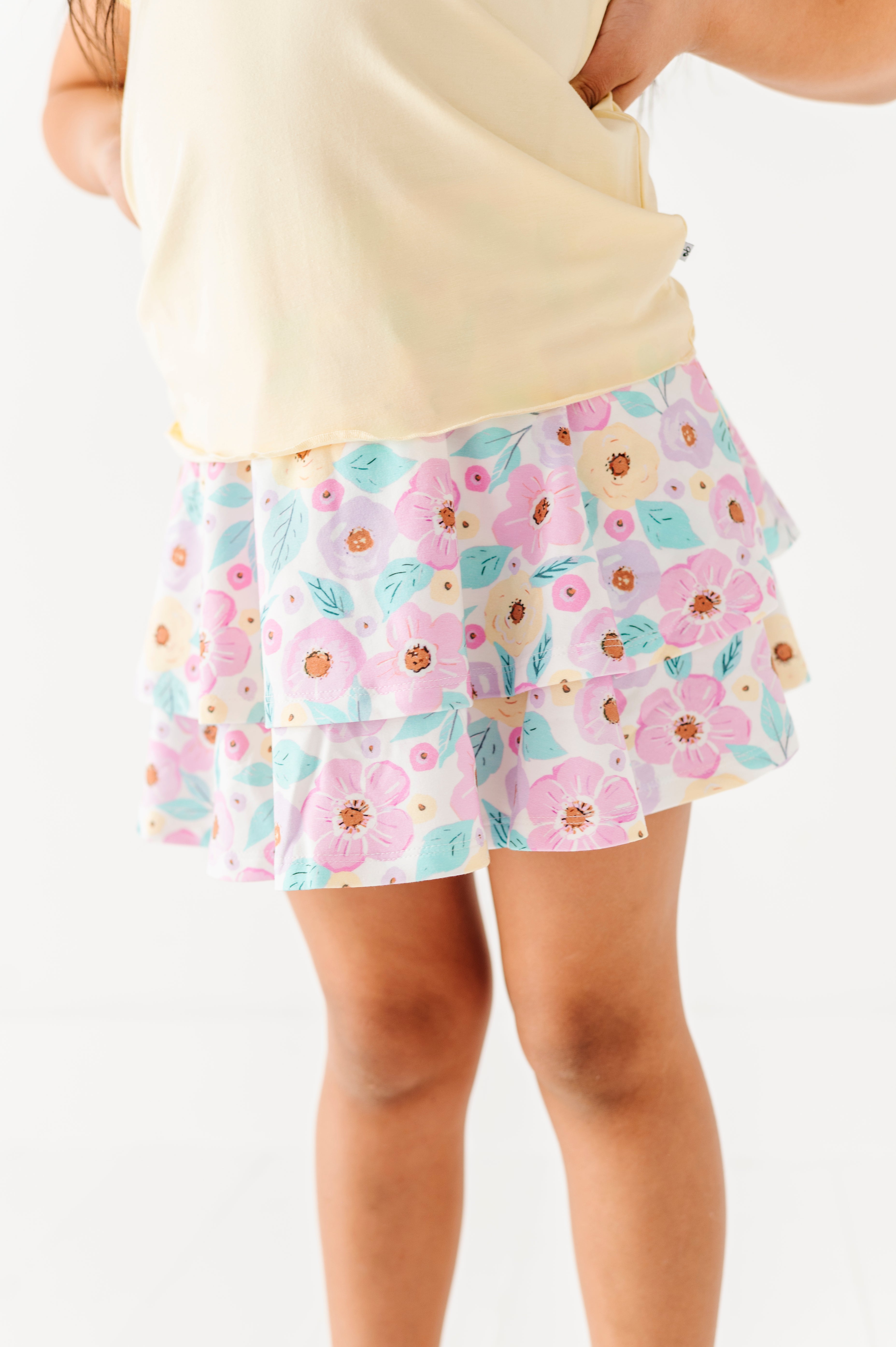 Floral skort worn by a person on a white background