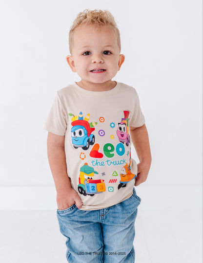 Little boy wearing a bamboo t-shirt with Leo the Truck graphic on a white background