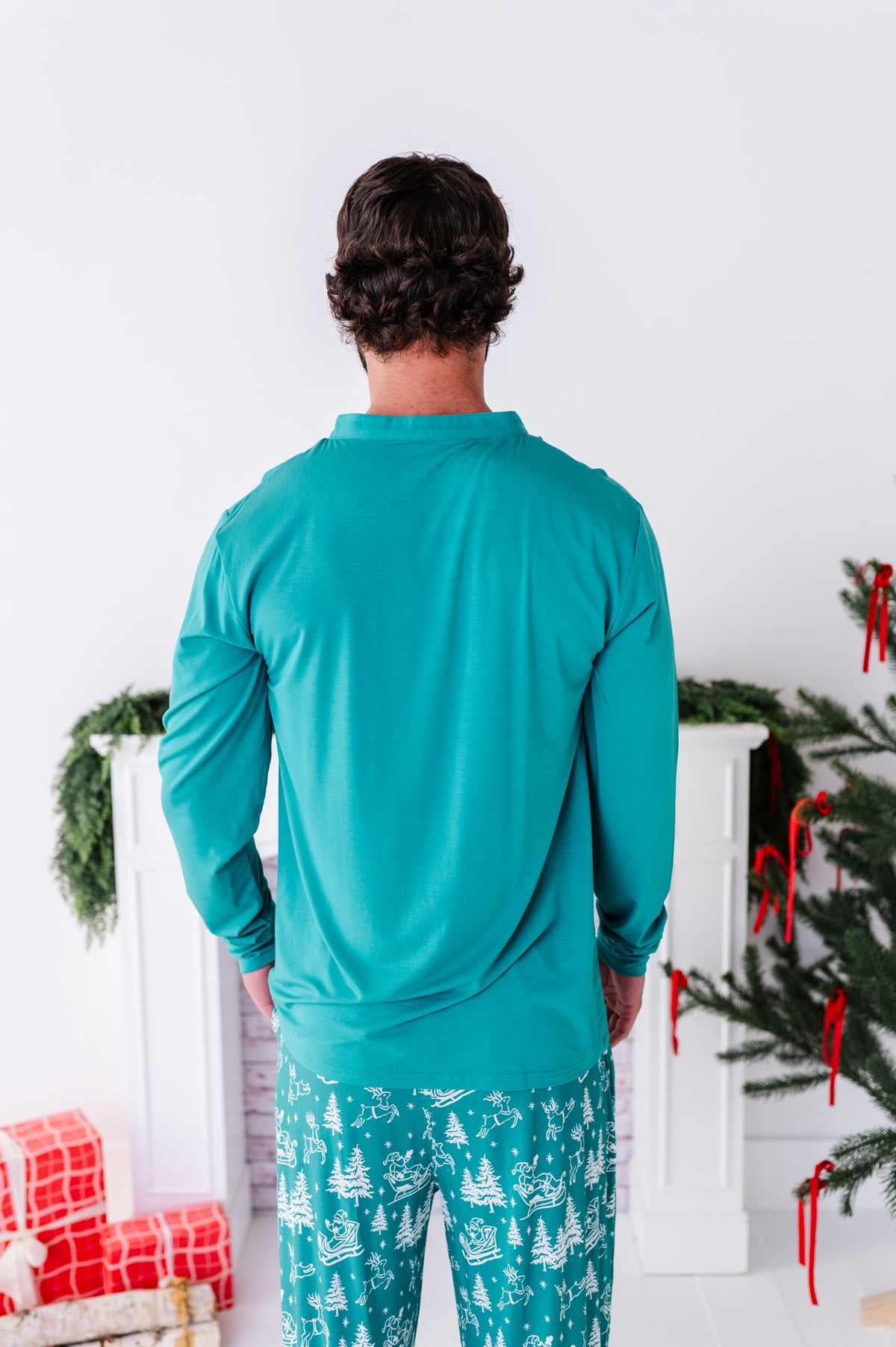 A man standing with his back to the camera wearing bamboo Christmas pajamas 