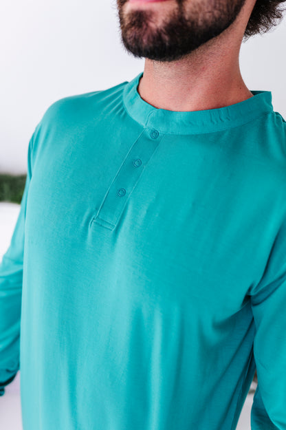 A close-up detail shot of a solid green henley bamboo pajama tee 