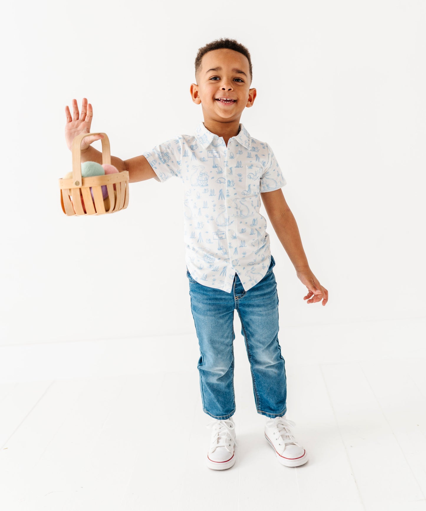 Child holding a wooden easter basket  on a white background