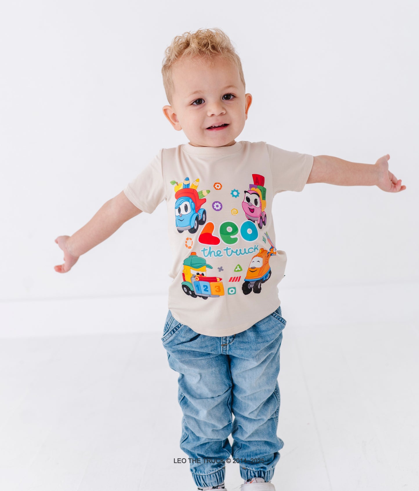 Toddler boy wearing a bamboo tee with colorful Leo the Truck graphics on a white background