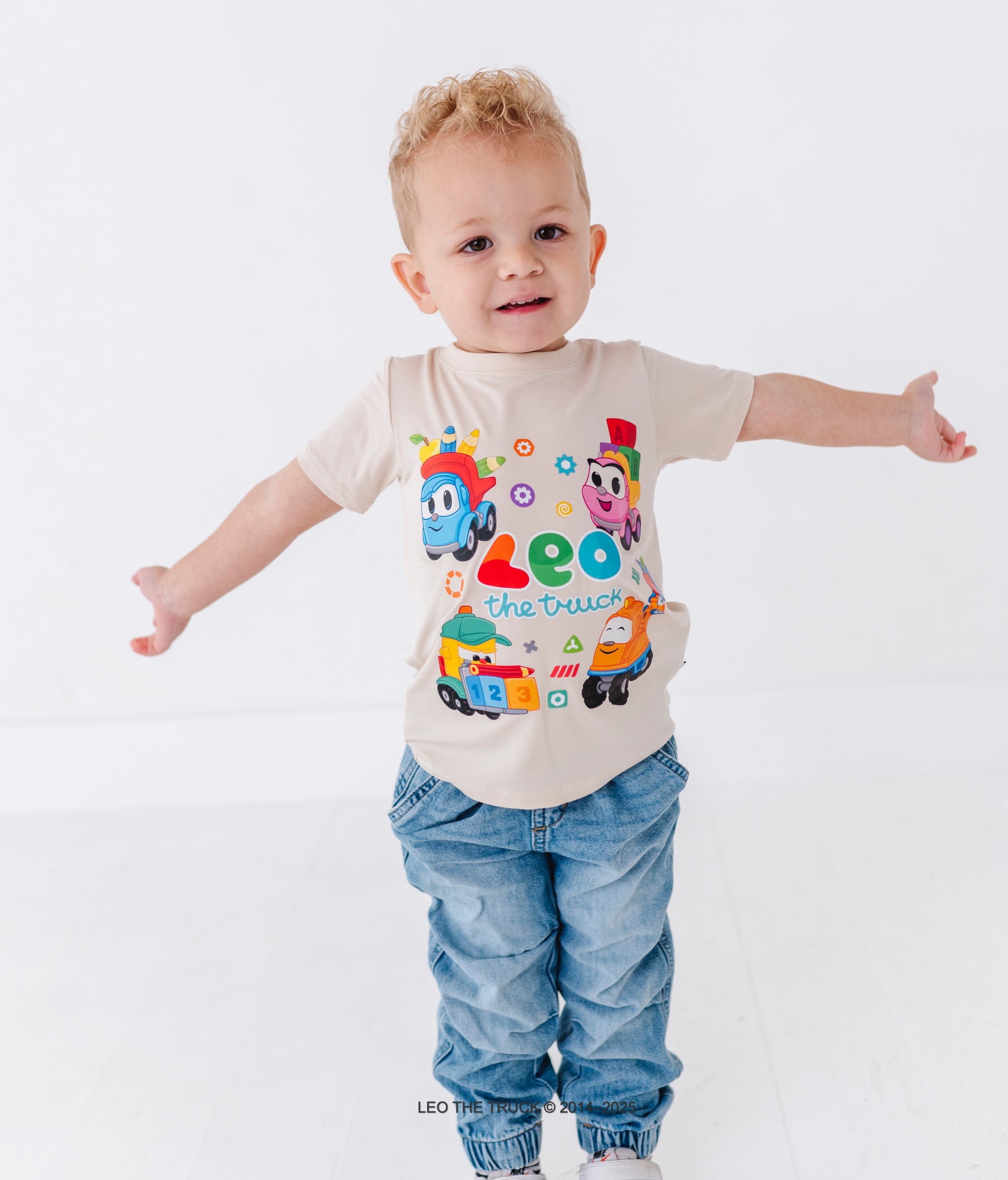 Toddler boy wearing a bamboo tee with colorful Leo the Truck graphics on a white background